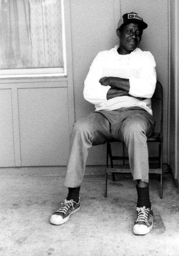 Robert Dennis sitting on his porch- Belle Glade, Florida.