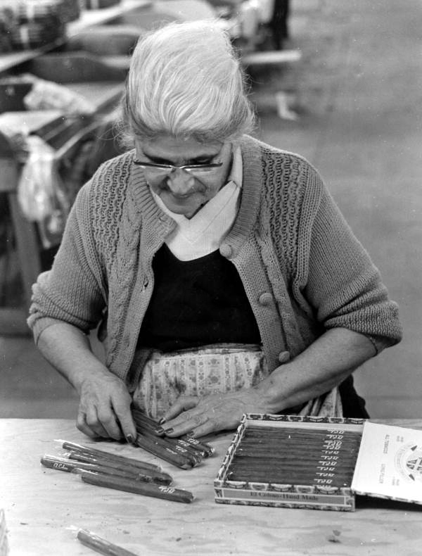 Consuelo Fernandez putting cigars she rolled into a box- Tampa, Florida