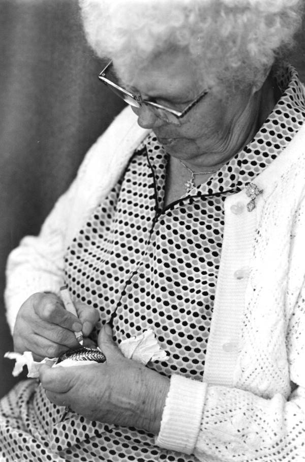 Woman painting a pysanky egg