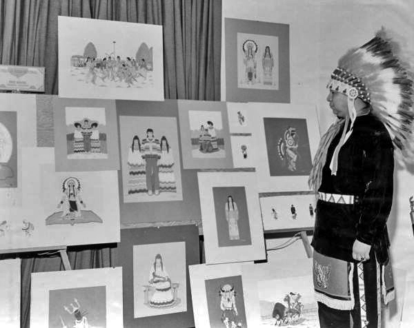 Creek Indian painter Fred Beaver looking at his artwork at the 1954 Florida Folk Festival- White Springs, Florida