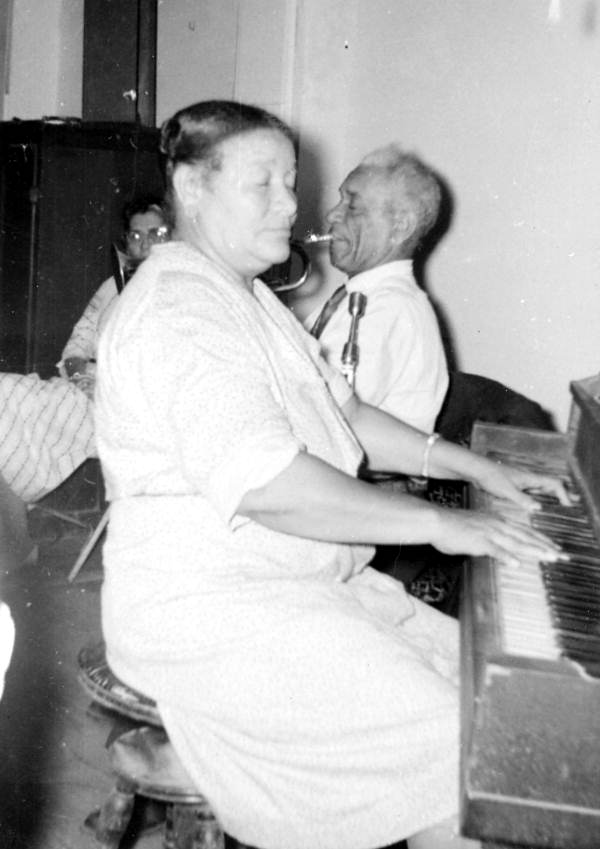 Billie Pierce at piano with her husband "De De" on trumpet playing jazz, ragtime and blues music.