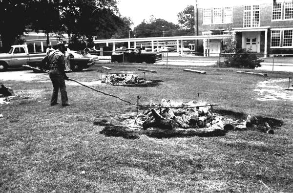 Man setting up ring for mullet fish smoke - Monticello, Florida