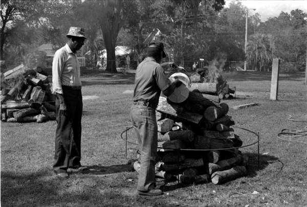 Men preparing wood for mullet fish roast - Monticello, Florida
