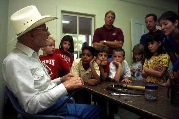 Curly Dekle, cow whip maker with school children - White Springs, Florida.