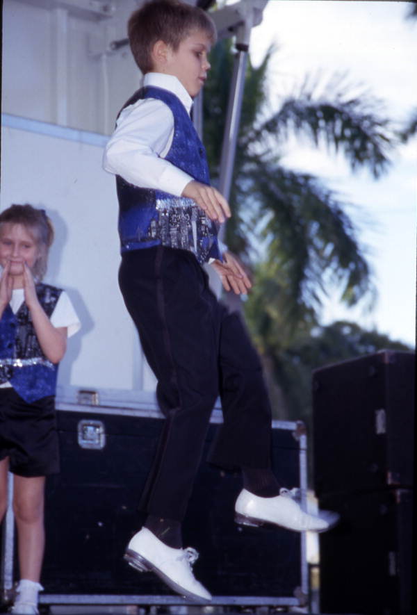 Young member of Country Rhythm Cloggers performs on the stage - Fort Myers, Florida.