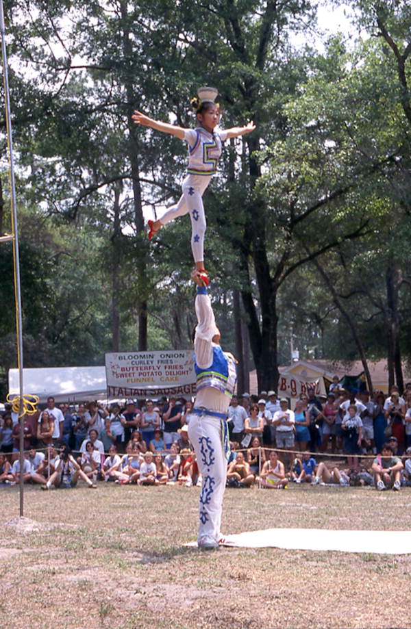 Xuefei Leng lifts Dan Dan Zhao during a performance at Florida Folklife Festival - White Springs, Florida.