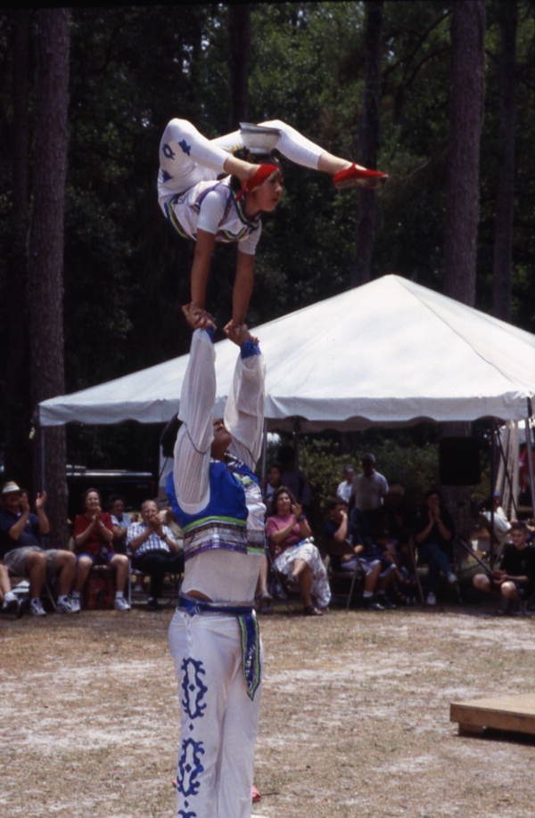 Xuefei Leng hold Dan Dan Zhao in the air at the Florida Folklife Festival - White Springs, Florida.