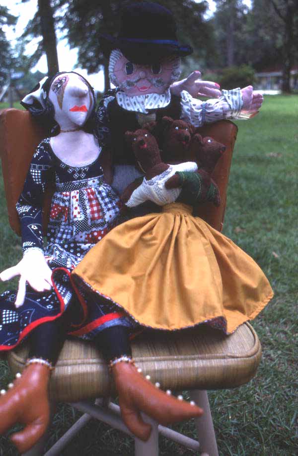 Dolls made by Mildred Bowen sitting on a chair