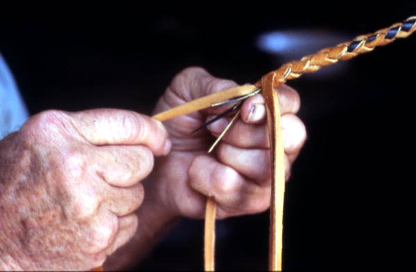 Claude Sheppard in the process of braiding a whip - Gainesville, Florida.
