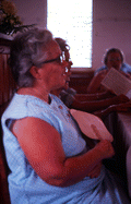 Woman singing from Sacred Harp book at the Bethlehem Primitive Baptist Church - Old Chicora, Florida