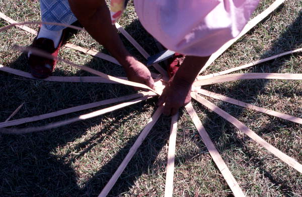 Lucreaty Clark making a basket by hand weaving strips of white oak