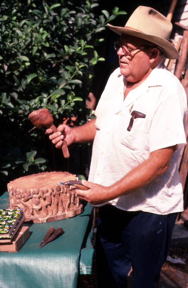 John Albert holding items he uses to make wood sculptures- Tampa, Florida