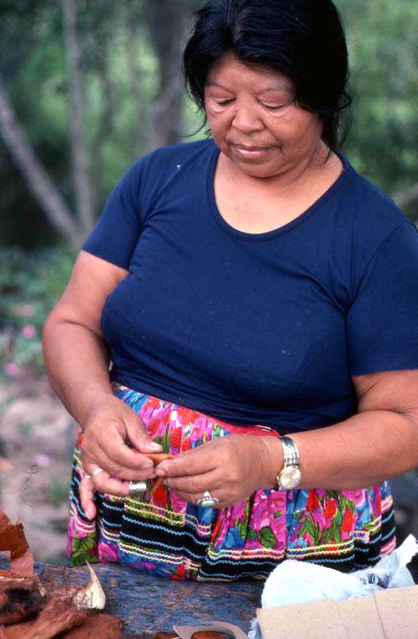 Mary Billie wrapping palmetto fiber around cardboard for the Seminole doll she is making - Big Cypress Reservation, Florida