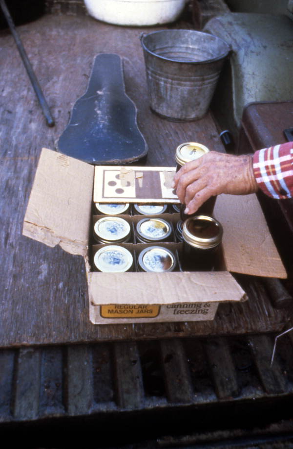 Jars of sugar cane syrup being put in a box - Orlando, Florida.