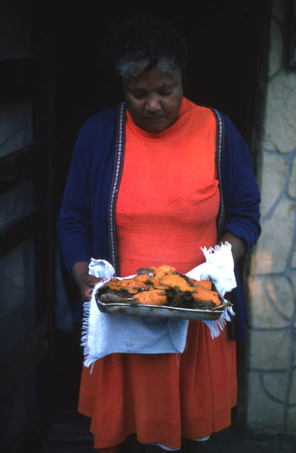 Dessie Oliver serving the cooked opossum - Tampa, Florida.
