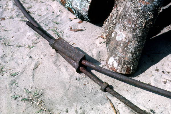 Close-up view of link between iron rods that ring the fire used to roast mullet - Monticello, Florida