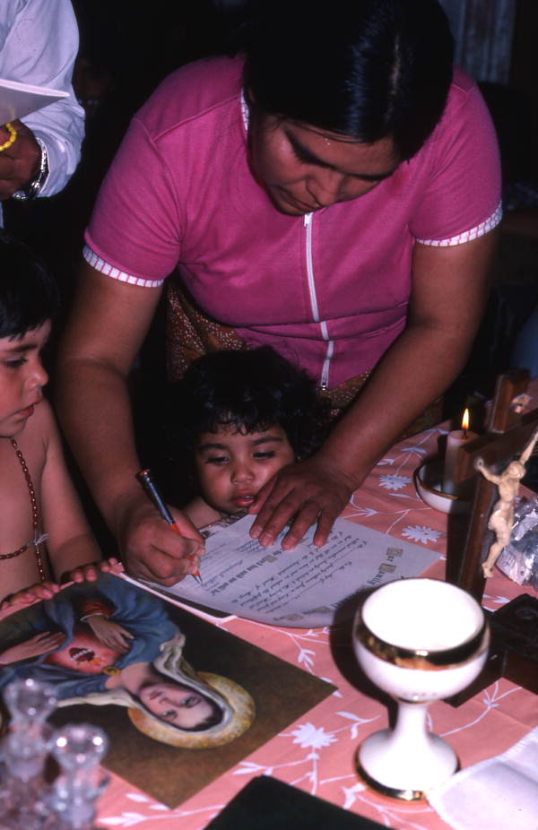 Woman signing papers to have a picture of the Virgin of Fatima in her house - Emporia, Florida