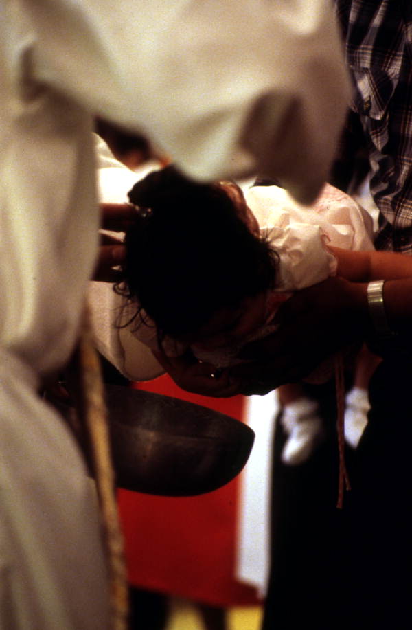 Child being baptised - Seville, Florida