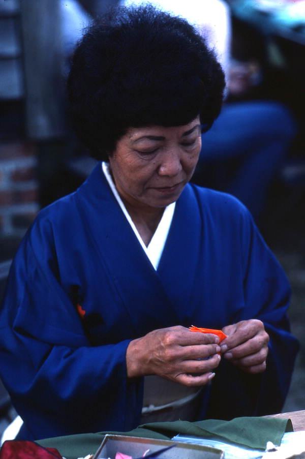 Kazuko Law making origami at the Great Gulf Coast Arts Festival- Pensacola, Florida.