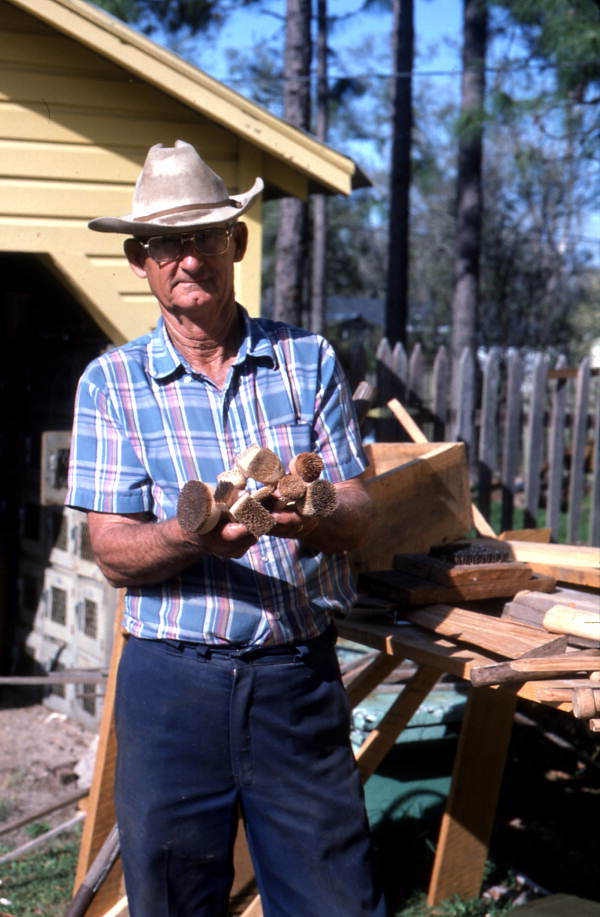 Woodworker Charlie Lewis with pieces of wood - Perry, Florida.