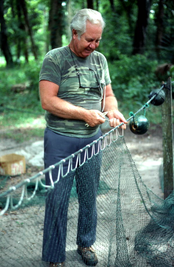 Net maker Martin Cooper repairing a shrimp trawl net - Jacksonville, Florida