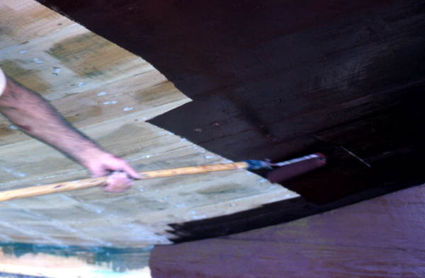 Painting the bottom of a boat being built - Jacksonville, Florida.