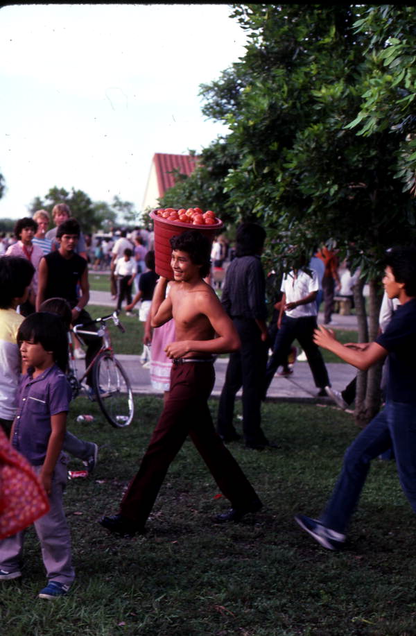 Participant from the Mexican Independence Day tomato picking contest walking with his pail - Florida City, Florida