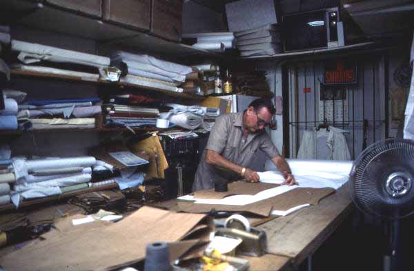 Ramon Puig cutting a pattern to make clothing - Miami, Florida.