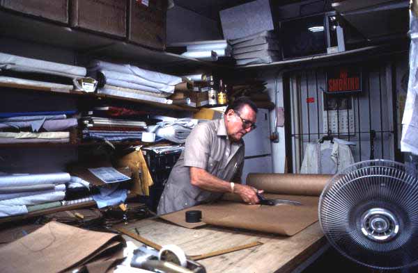 Ramon Puig cutting a pattern to make clothing - Miami, Florida.