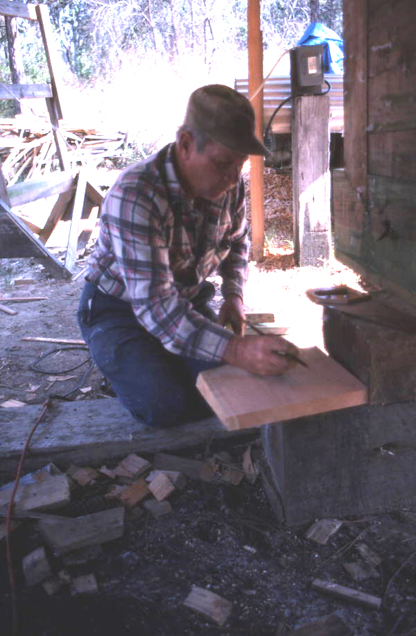 Bud Seymour records measurements for new planks on a scrap of wood - Apalachicola, Florida