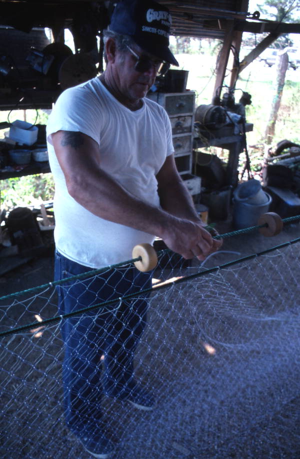 Sonny Polous working on a monofilament mullet net - Apalachicola, Florida