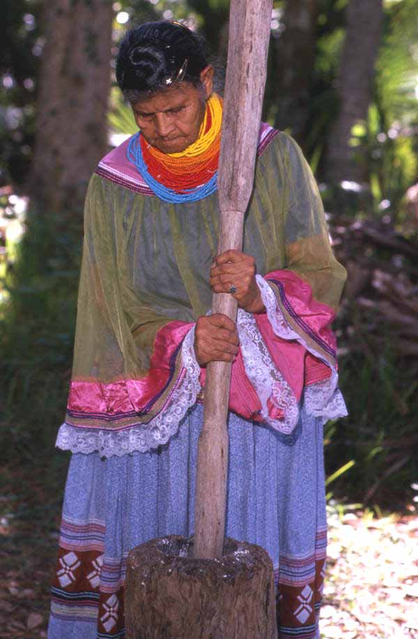 Lottie Shore grinding corn - Brighton Reservation, Florida