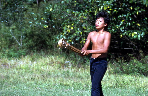 Seminole boy playing stick ball - Big Cypress Reservation, Florida