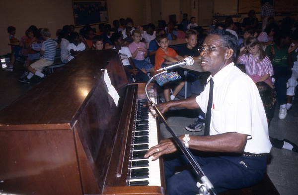 Alex McBride playing blues piano at Pine Estates Elementary School - Jacksonville, Florida.