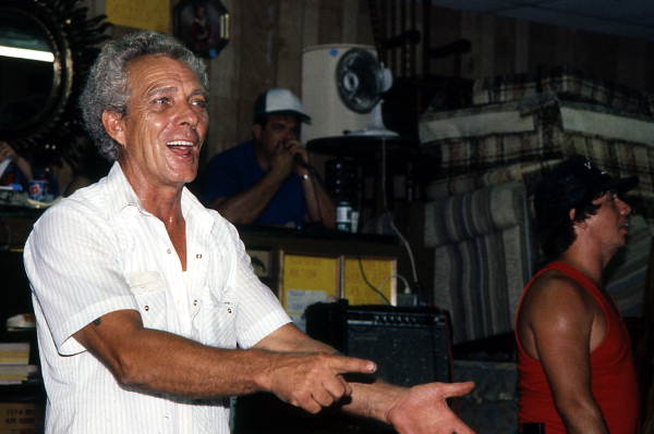 Furniture store owner pointing out bidders during auction led by auctioneer Randy Kerr - Jacksonville, Florida.