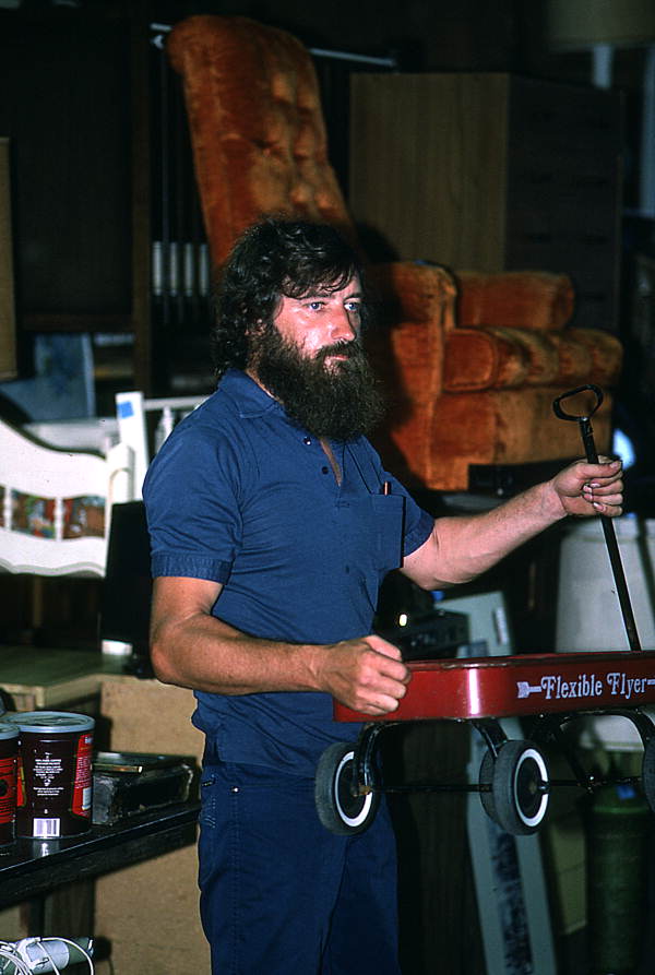 Furniture store personnel holding up toy wagon as handler during auction - Jacksonville, Florida