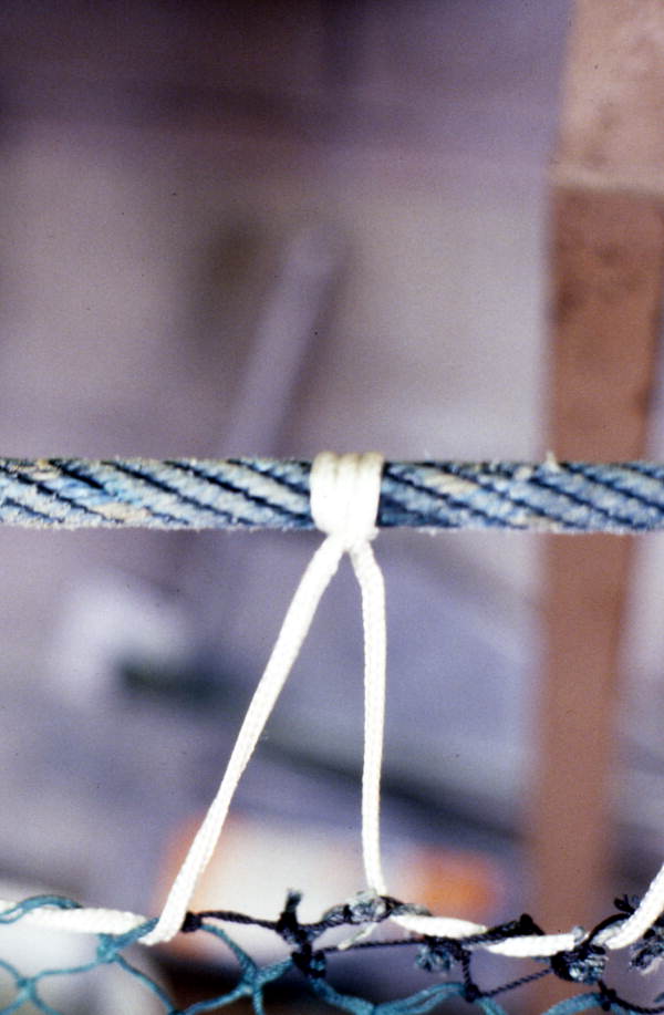 Detailed view of a fishing net being knitted by Rickey Doublerly - Jacksonville, Florida.