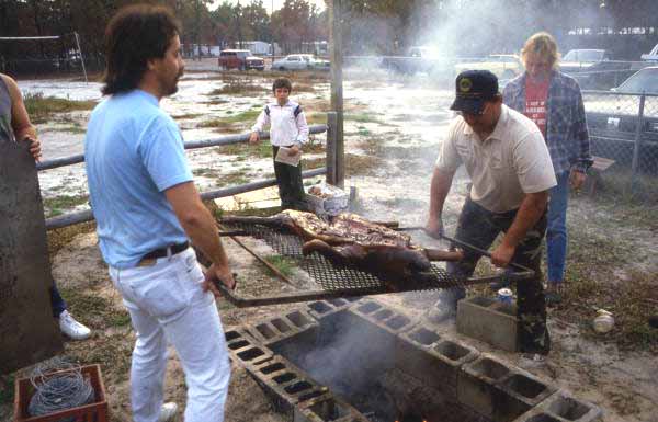 Removing the lechon from the barbecue pit - Jacksonville, Florida