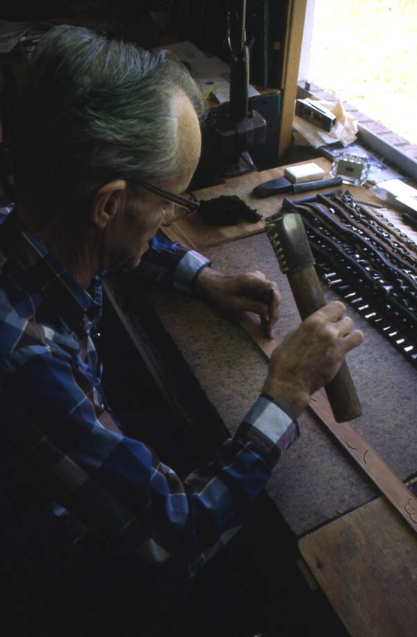 Leather worker Bob Dellis working - Okeechobee, Florida