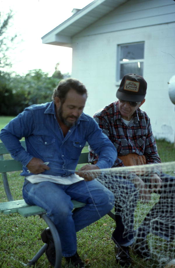 Reginald Reis making a cast net while Max Dooley observes - Lakeland, Florida