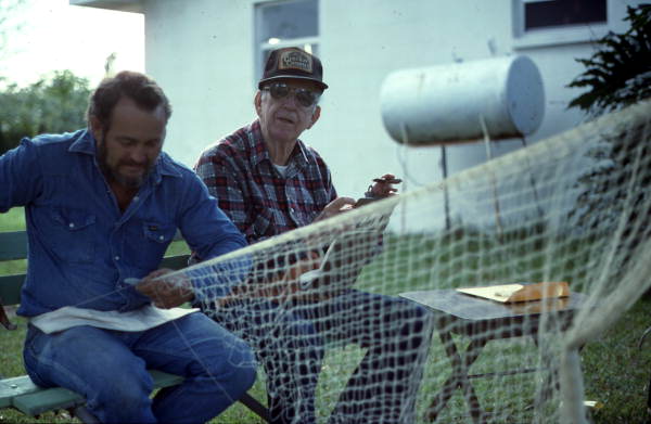 Reginald Reis making a cast net while Max Dooley observes - Lakeland, Florida