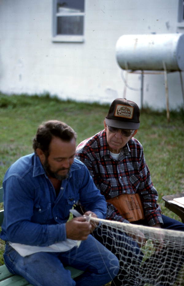 Reginald Reis making a cast net while Max Dooley observes - Lakeland, Florida