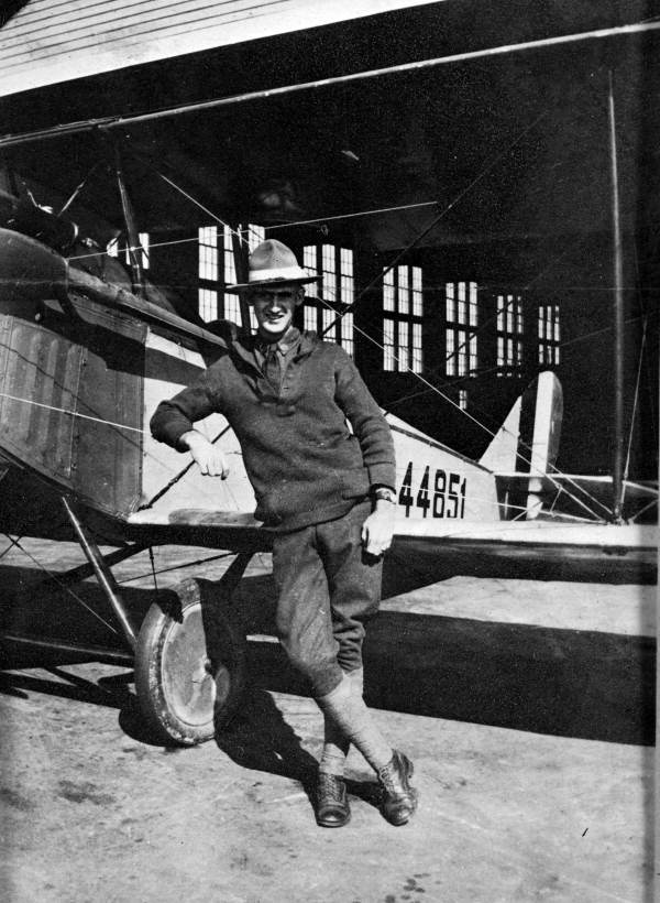 Man posing with plane at Carlstrom Field - Arcadia Region, Florida.