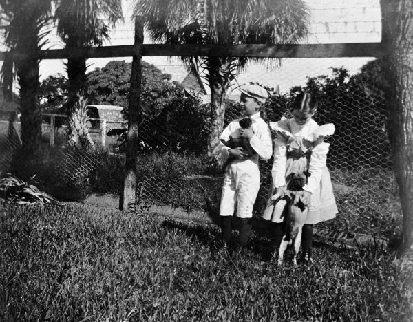 Children with pug dog and puppy - Courtenay, Florida.