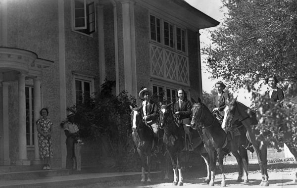 Four riders outside a mansion - De Land, Florida
