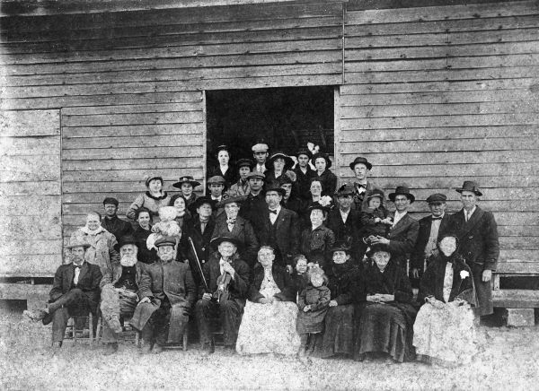 Large unidentified group posed next to a building - Havana, Florida.