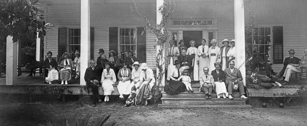 Guests on the porch of the main cottage.
