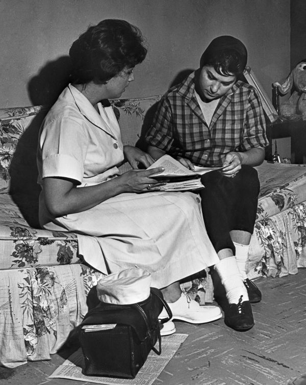 Young Cuban woman visited at home by Spanish-speaking nurse - Miami, Florida.