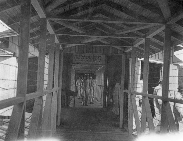 Prisoners in passageway between bunk house and mess hall