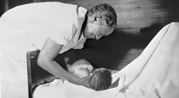 Midwife holding just delivered baby